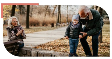 Elderly family in park with grandchild